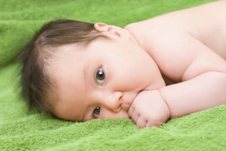 A one month old caucasian brunette baby