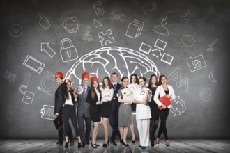 Woman stands beside big drawn brain on the gray wall