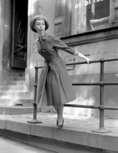 Fashionable in the 1950s. A young woman wears a typical 1950s dress. The pattern is dotted and the