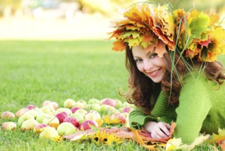 Woman with maple leaves outdoors. Close up face