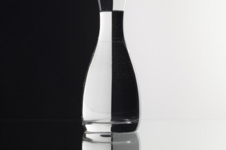 Glass of water on the black and white background on the glass table