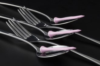 Forks and spoons on a black table