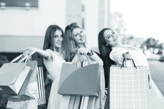 Three young women posing on a summer day in the city