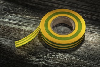 Yellow insulating tape on vintage wooden board