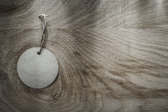 Round price tag on wooden board