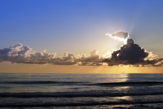 Photographic documentation of clouds at sunset over the sea