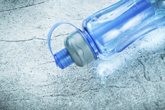 Water bottle for doing sports on silver background fitness concept