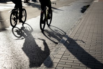 Silhouette of unrecognised people cycling outdoor in the morning. People exercising. Healthy