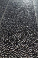 Rolling stones pavement soil texture in Altea Alicante mediterranean village of Spain