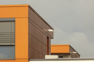 Ultra modern office building with windows and orange walls