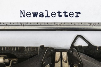 A vintage typewriter with the word newsletter
