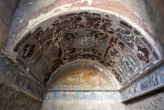 POMPEII, ITALY, MAY 04, 2022, Beautiful colorful stucco in a room niche of a Pompeian villa,