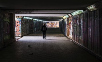 Freattyda, Athens, Greece, 12 28 2019 Torusit walking under a dark underpass tunnel, Europe