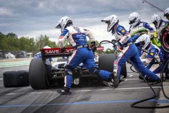 LINUS LUNDQVIST (R) (8) of Stockholm, Sweden comes down pit road for service during the XPEL Grand