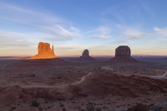 A picture of the Monument Valley landscape at sunset, with the West Mitten Butte, East Mitten Butte