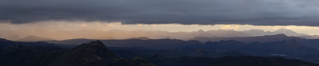Cloudy mood and evening light at sunset, view from Mount Sveinstindur, volcanic landscape,