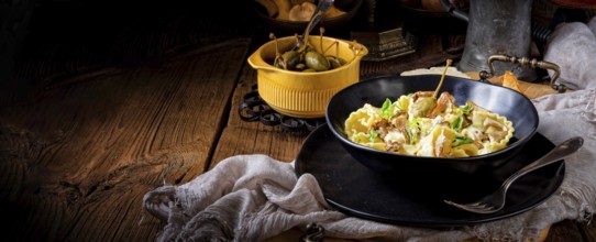 Reginette noodles in cream sauce with fresh chanterelles and capers