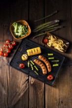 Grilled krakauer with french fries and green salad
