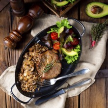 Pork steak with mushrooms and buckwheat groats and mango salad