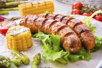 Grilled krakauer sausage with boiled corn and green salad