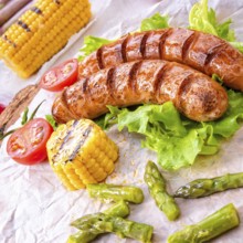 Grilled krakauer sausage with boiled corn and green salad
