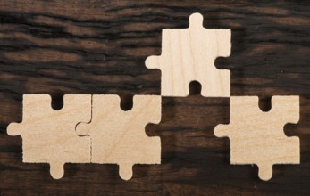 Wooden puzzle on dark wooden background