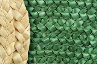 Woven straw natural background. Green and beige colors