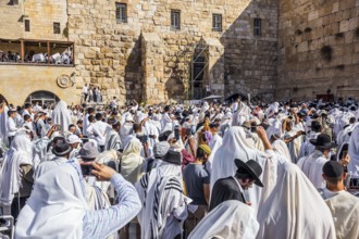 The ceremony at the Western slope of the Temple Mount in Jerusalem. Jews praying in festive white