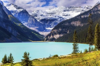 Travel to the Rocky Mountains of Canada. The lake with azure water is surrounded by mountains and