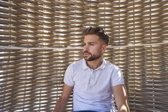 Young beard man relaxed in a beach hammock