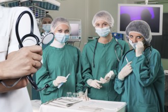 Doctor holding stethoscope over surgeons team prepare to operation