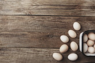 Organic chicken eggs in metal box on wooden background in a row. Organic household concept with