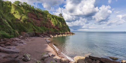 Clouds over the beach in Maidencombe, Torbay, England, UK