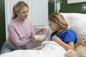 A caring moment between a mother and her daughter, showcasing love and support in a hospital