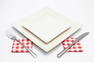 White square plate on the white wooden table.Top view.Flat Lay Image