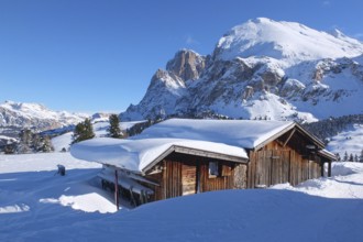 Wooden challet in the Dolomites mountain in winter
