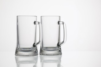 Empty glasses of beer on the glass desk