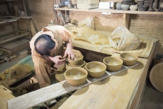 Potter working on bowls in a korean folk village, South Korea, Asia