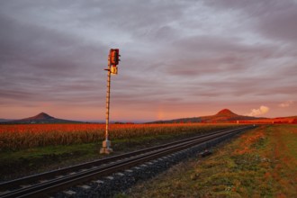 Morning train to the hell. Old Railway tracks running through a field stretch to rural countryside