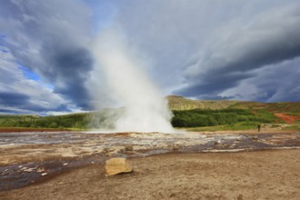 Iceland in the summer. Gushing geyser Strokkur. High column of hot water and steam from the crater