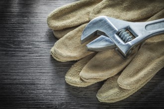 Adjustable tensioner protective gloves on wooden board