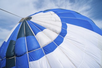 Blue Balloon in the blue cloudy sky