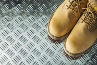 Waterproof safety boots on corrugated metal plate