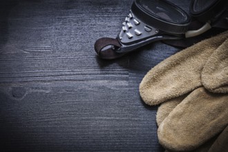 Working goggles and protective gloves close up