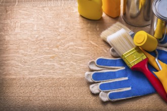 Work tools on protective gloves paint cans and bottles maintenance concept