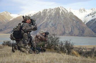 Two hunters searching for Himalayan tahr in the Southern Alps of New Zealand