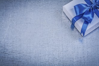 Present box blue bow on metallic background copyspace celebrations concept