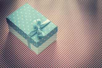 Present box on stripy tablecloth celebrations concept