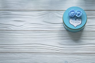Round blue present box on wooden board celebrations concept