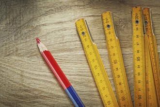 Wooden meter pencil on wood board construction concept